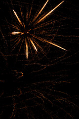 fireworks with yellow sparks on black background