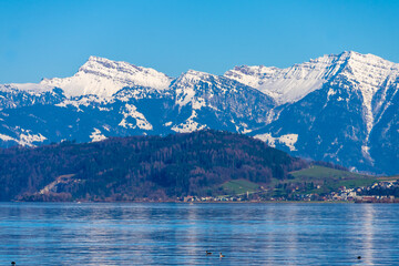 Obraz premium Stunning alpine landscapes along the shores of the Upper Zurich Lake with the iconic Santis peak in the background, Rapperswil-Jona, St. Gallen, Switzerland