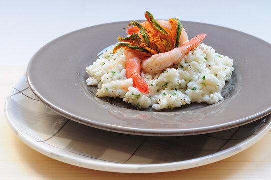 Risotto with scampi and courgette flowers (ph. Archivio Collection)