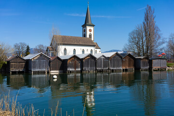 Fototapeta premium Beautiful scenery along of small harbor of the idyllic lakeside village of Busskirch, Rapperswil-Jona, St. Galen, Switzerland