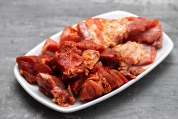 marinated raw meat and ribs on white dish