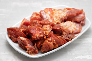 marinated raw meat and ribs on white dish