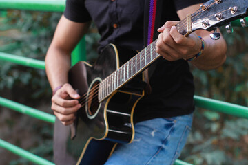 musician playing guitar outdoors