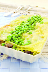 Lasagna with rabbit meat and green peas (ph. Archivio Collection)