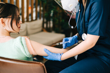 Obraz premium Caucasian woman patient getting vaccinated against coronavirus receiving covid vaccine. Intramuscular injection during doctor's appointment in hospital. Covid-19 Vaccination.