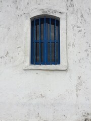 Old Blue Window in the White Wall