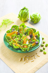 Chickpea salad with lettuce, olives, pine nuts and carrots (ph. Archivio Collection)