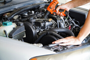 Fototapeta na wymiar Auto mechanic working in garage. Repair service,Car check concept