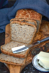 Homemade whole grain bread with with seeds. A piece of bread with butter