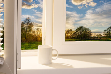 open window with a cup of coffee on the windowsill