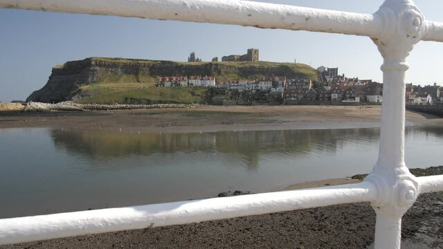 Shot through railings of River Esk and St. Mary's Church, Whitby, North Yorkshire, England, United Kingdom, Europe