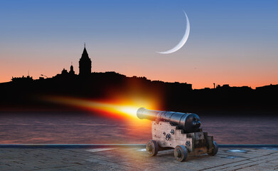 Ramadan Concept - Ramadan kareem cannon with crescent - Night sky with moon in the clouds at sunset - Istanbul
