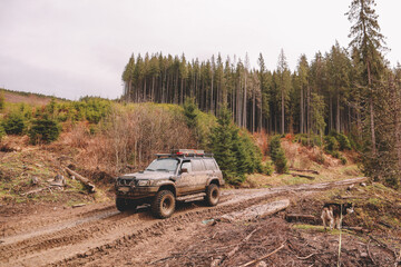 Dirty cars and wheels in the mountains. Swamp on the tires. Trips offroad across Ukraine. View of...