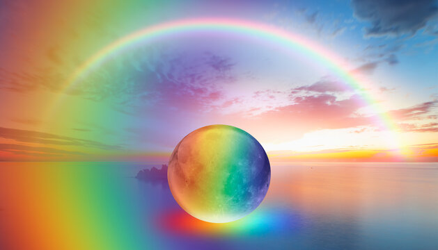 Full glass moon (or crystal ball moon) rising over empty sea with double sided rainbow