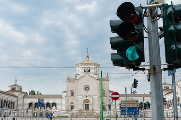 Green traffic light on the right. Urban traffic with the facade of 