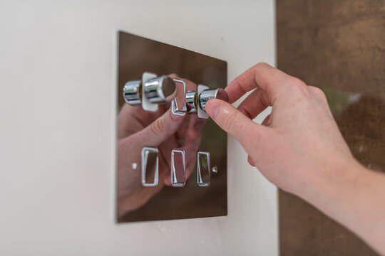 Modern dimmer light switch used being lowered for dimmer lighting and to save electricity 