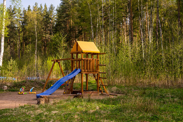 Fototapeta na wymiar Summer kids playground in the forest. Outdors training and play