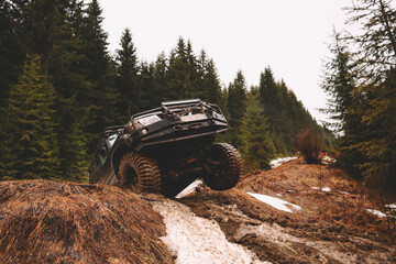 Offroad car jump in the mountains. Pollen, swamp and snow. Affortation, suspension, tires - obrazy, fototapety, plakaty