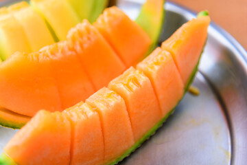 piece of fresh orange melon on the plate