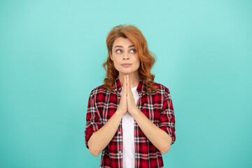 praying redhead woman with curly hair in checkered casual shirt, please
