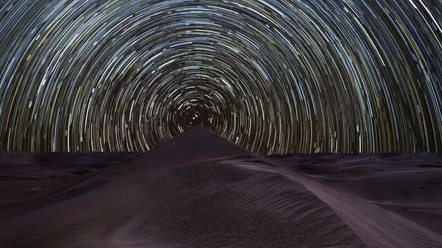 Night time lapse of a circumpolar concentric star trail in the Rub Al Khali desert, Oman, Middle East