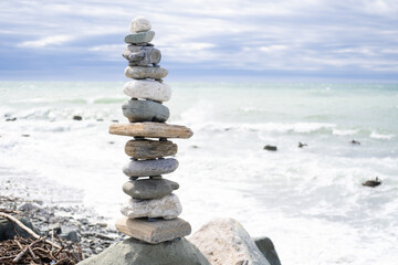 Stacks of balanced round stones on beach. Zen concept