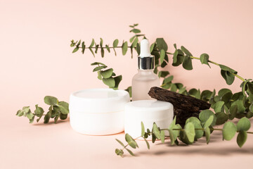 Natural cosmetic concept. Skincare product with natural leaves and tree bark at pastel background.