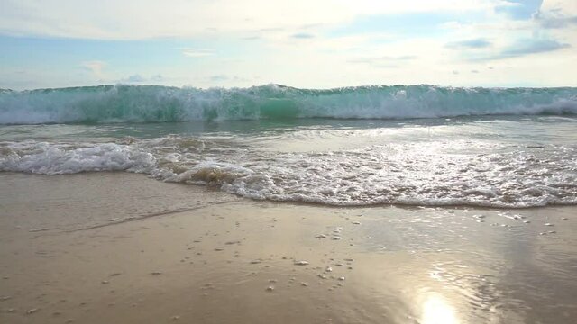 Slow motion shot Close up of wave crashing on the tropical beach in sunny day and wave moving towards camera Hand held shot of Sea waves