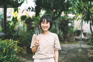 Naklejka premium Happy young adult asian woman at home garden on day.