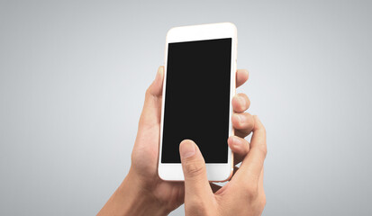 Hand holding smartphone device touching screen