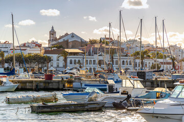 Boats in marina of Lagos with old town behind, Algarve, Portugal - obrazy, fototapety, plakaty