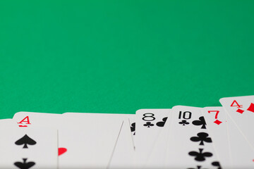 Classic playing cards on green background. Gambling and casino concept.