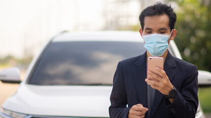 Asian man wear facemask protect covid19 coronavirus outbreak and using smartphone lifestyle outdoor street urban
