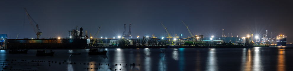 panoramic night scene and long exposure Container oil ship repair in shipyard