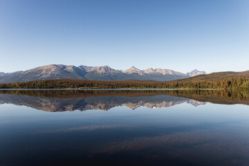 Obraz premium Pyramid Lake in Jasper National Park with gorgeous reflections of hills and trees in the water