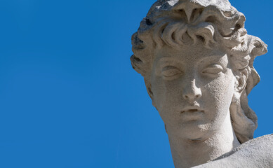 Fototapeta na wymiar The goddess of love in Greek mythology, Aphrodite (Venus in Roman mythology) Close up fragment of an ancient statue. Horisontal image.