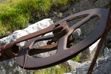 Old iron pulley used in marble quarries to cut stone.Iron wheel used as a pulley for the helical...