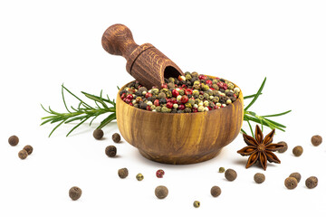 Wooden bowl with a mixture of peppers and scattered spices isolated on a white background.