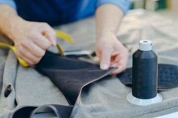 Closeup shot of a worker sewing in a textile factory