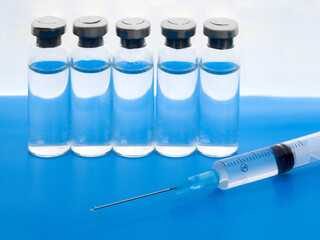 Close-up medical syringe and vials with medicine for injection