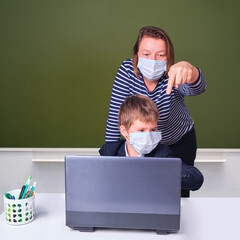Teacher and schoolboy during distance learning in elementary school, concept of problems on...