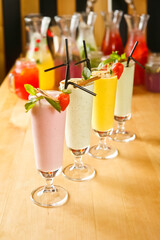 colorful cocktails with ice and decorated with fruits