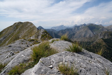 Mountain ridge in Alta Versilia, Monte Corchia.Alpine panorama on the Apuan Alps. In the background the peaks of the Garfagnana mountains. Alpi Apuane, Tuscany, Italy.