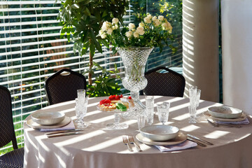 white set table with crystal and flowers