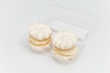 white marshmallows in plastic transparent packaging on a white background