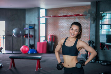Beautiful asian woman play fitness in the gym,Thailand girl has a slim body,Time for exercise,People love heath,Stretching body before workout,Sport woman warm up body,push up with dumbell