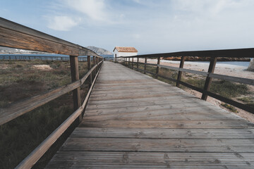 Fototapeta na wymiar Closeup shot of a wooden path near the Mediterranean sea in Spain