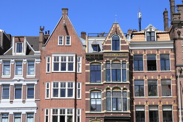 Fototapeta na wymiar Amsterdam Schippersgracht Canal House Facades Against a Blue Sky