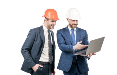 two businesspeople men partners in suit and safety helmet work on laptop online, business partners.