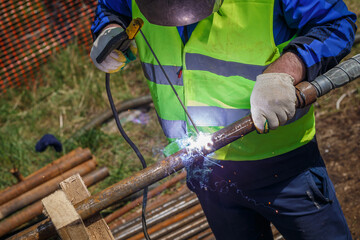 welding work man outdoors welding pipe mask